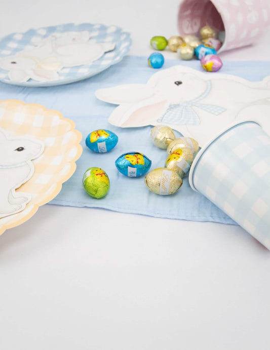 Mise en scène sur une table des assiettes festonnées Vichy Pastel pour fête