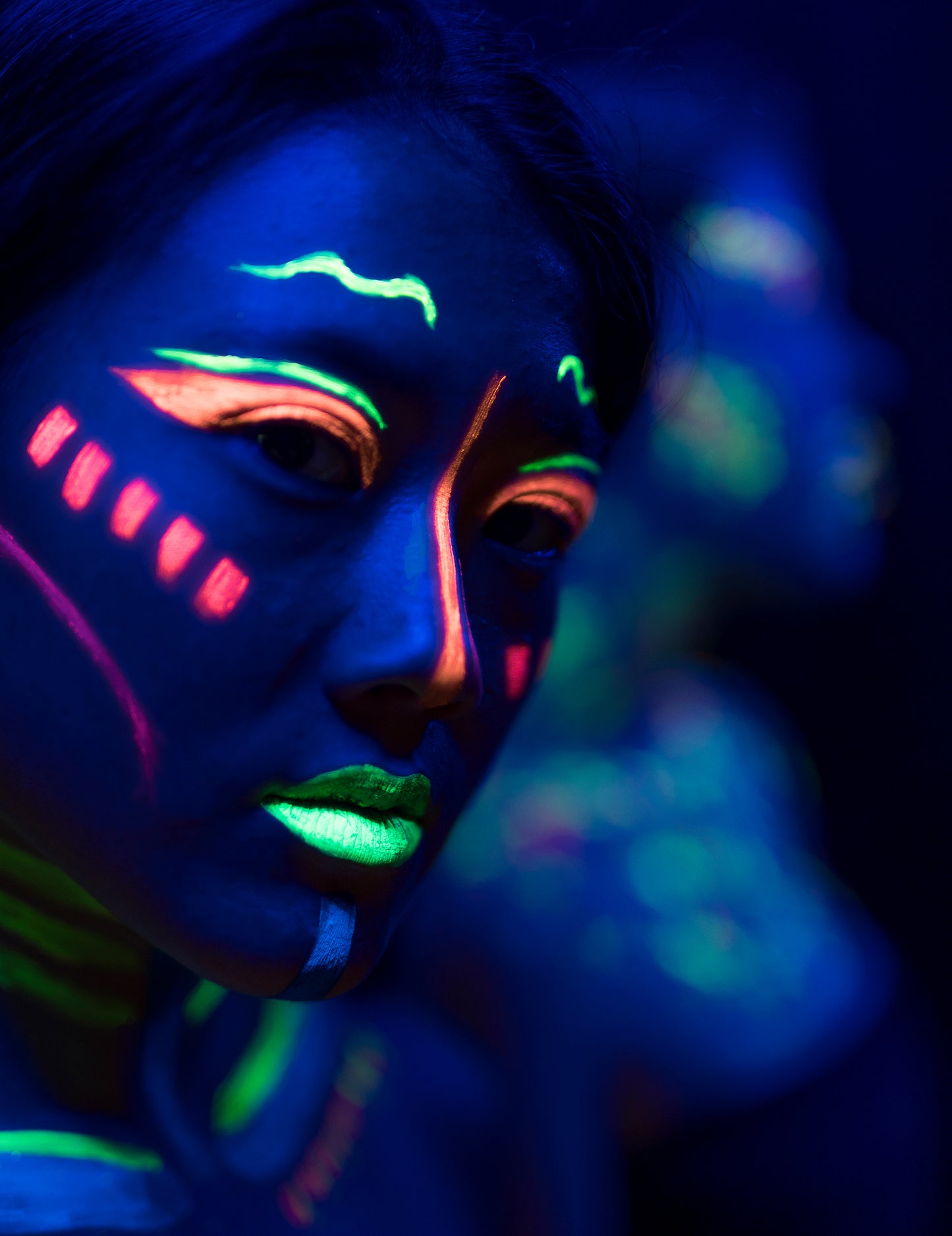 Gros plan sur le rendu fluo sur le visage du kit maquillage néon