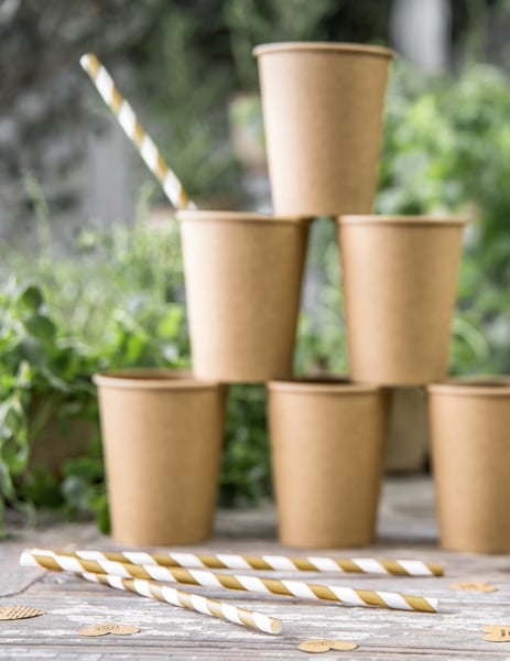 Mise en scène avec pyramide de gobelets des pailles en carton rayées blanches et dorées mat