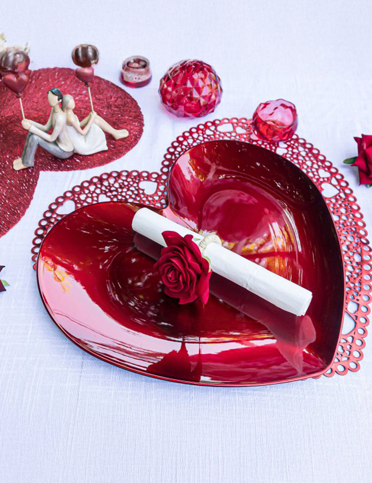 Mise en situation sur une assiette cœur du ronds de serviette roses pour décoration de table