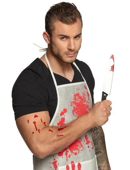 Plastový nôž na Halloween s krvavým efektom držený v ruke