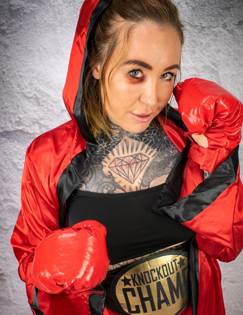 Gros plan sur le peignoir à capuche et les gants du déguisement de boxeuse pour femme rouge