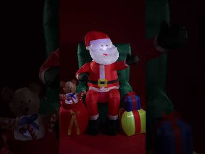 Nafukovacia pohyblivá dekorácia sediaci Santa Claus s darčekmi 122 cm 